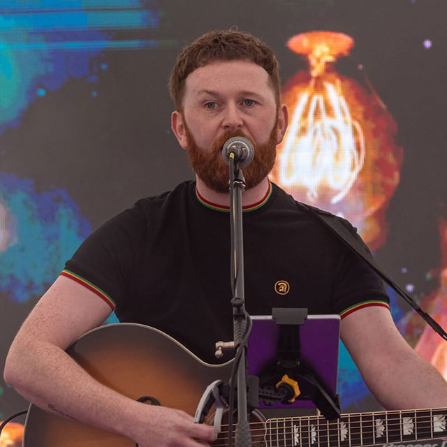 Man playing guitar and singing