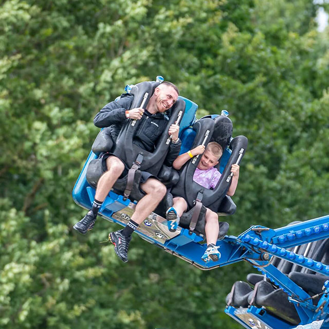Father and son on a fairground ride